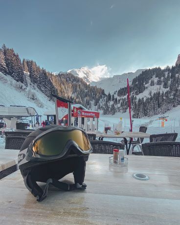 Ski Goggles on helmet with mountain background
